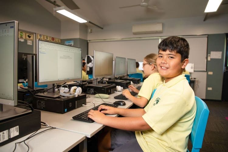 student on the computer working in class