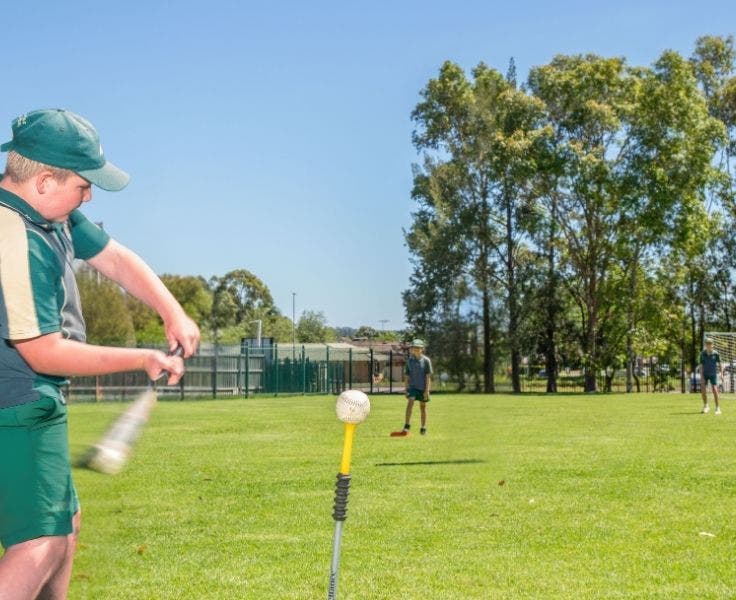 student hitting the T'Ball