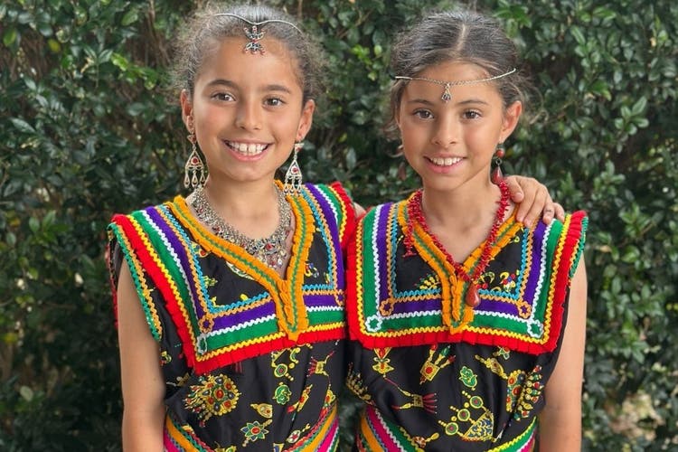 two students wearing their cultural outfits
