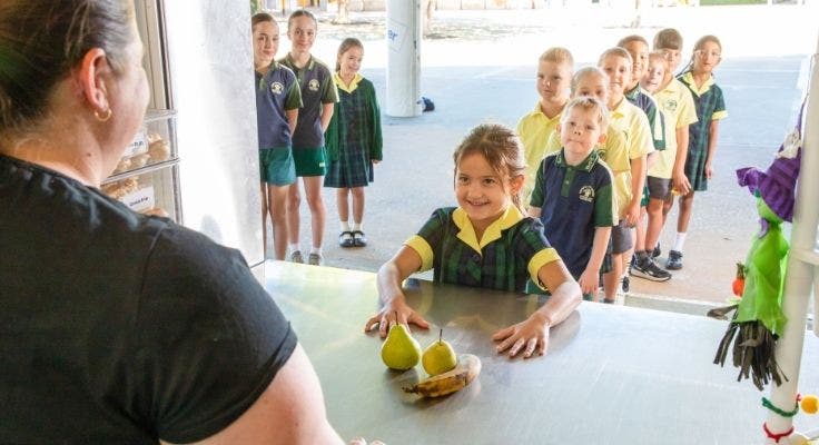 students being served fruit at the canteen