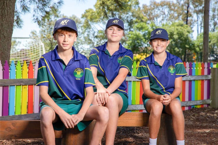 3 students sitting in the friendship garden