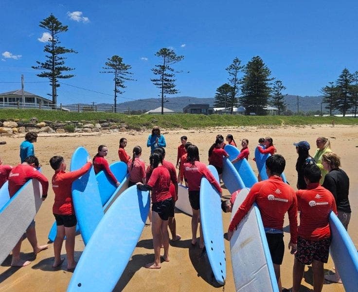 students on excursion and learning to surf