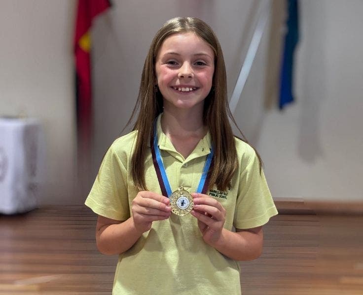 students with her medal for public speaking